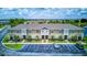 Aerial view of townhome exteriors with manicured landscaping and ample parking at 322 Annabelle Way, Davenport, FL 33837