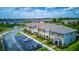 Aerial view of townhome exteriors with manicured landscaping and parking spaces at 322 Annabelle Way, Davenport, FL 33837