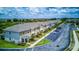 Aerial view of townhome exteriors with manicured landscaping and ample parking spaces at 322 Annabelle Way, Davenport, FL 33837