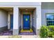 Close-up of townhome's welcoming entrance showcasing a sunflower-themed front door at 322 Annabelle Way, Davenport, FL 33837
