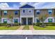 Attractive townhome exterior featuring a landscaped yard and inviting entryway at 322 Annabelle Way, Davenport, FL 33837