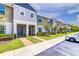Charming townhome with manicured lawn, colorful landscaping, and convenient parking at 322 Annabelle Way, Davenport, FL 33837