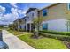 Inviting townhouse with well-maintained landscaping, lush lawn, and a sidewalk at 322 Annabelle Way, Davenport, FL 33837