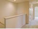 Bright upstairs hallway with white walls and carpeting, leading to various rooms at 322 Annabelle Way, Davenport, FL 33837