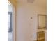 Hallway showcasing a side table, mirror, and doorway leading to other areas of the home at 322 Annabelle Way, Davenport, FL 33837