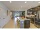 Spacious kitchen with stainless steel appliances and an island with bar seating at 322 Annabelle Way, Davenport, FL 33837