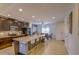 Open-concept kitchen with stainless steel appliances, a kitchen island, and tiled floors at 322 Annabelle Way, Davenport, FL 33837