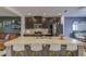 Kitchen island with granite countertop, stainless steel sink, and white bar stools with yellow legs at 322 Annabelle Way, Davenport, FL 33837