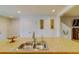 Kitchen island featuring a dual sink and granite countertops at 322 Annabelle Way, Davenport, FL 33837