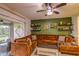 Living room with plush seating, ceiling fan, and sliding glass doors to the outdoor patio at 322 Annabelle Way, Davenport, FL 33837