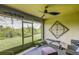 Relaxing screened patio featuring a ceiling fan, workout area and serene views of the yard at 322 Annabelle Way, Davenport, FL 33837