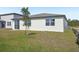 A new home has a backyard with a newly planted tree at 3253 Viceroy Ct, Poinciana, FL 34759