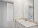 Bathroom with a vanity and framed mirror, as well as a view into an adjacent room at 3253 Viceroy Ct, Poinciana, FL 34759
