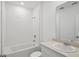 Bathroom features a shower-tub combo with white tile surround and vanity at 3253 Viceroy Ct, Poinciana, FL 34759