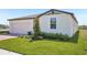 Well-manicured lawn and landscaped front yard enhance this modern single-Gathering home's curb appeal at 3253 Viceroy Ct, Poinciana, FL 34759