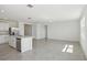 Open-concept living space featuring a kitchen with stainless steel appliances and abundant natural light at 3253 Viceroy Ct, Poinciana, FL 34759