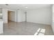 Bright, open-concept living room with neutral tile flooring and ample natural light, ready for your personal touch at 3253 Viceroy Ct, Poinciana, FL 34759