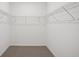Spacious walk-in closet featuring wire shelving and neutral carpeting at 3253 Viceroy Ct, Poinciana, FL 34759