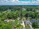 Aerial view of a home in a neighborhood with mature trees, pool, and community at 3325 Horseshoe Dr, Longwood, FL 32779