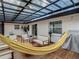 Enjoy this shaded back porch with seating and a hammock, perfect for outdoor relaxation at 3325 Horseshoe Dr, Longwood, FL 32779