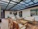 Inviting back porch with comfortable seating and bright, neutral cushions under a corrugated roof at 3325 Horseshoe Dr, Longwood, FL 32779