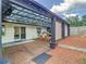 View of back yard with patio, corrugated roof, and mulched garden, ideal for outdoor entertaining at 3325 Horseshoe Dr, Longwood, FL 32779