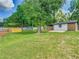 Spacious backyard with shade structure, bench, playset, and well-maintained lawn at 3325 Horseshoe Dr, Longwood, FL 32779