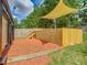 Backyard seating area featuring a shade structure and woodchips for landscaping at 3325 Horseshoe Dr, Longwood, FL 32779