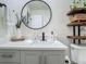 Bathroom with modern vanity, black faucet, quartz countertop, and decorative mirror at 3325 Horseshoe Dr, Longwood, FL 32779
