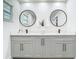 Modern bathroom featuring a double vanity with round mirrors and sleek black faucets at 3325 Horseshoe Dr, Longwood, FL 32779