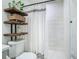 Elegant bathroom featuring a shower with white tile, shelving, and decorative shower curtain at 3325 Horseshoe Dr, Longwood, FL 32779
