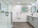 Bright bathroom with a glass-enclosed shower, double vanity, and modern fixtures at 3325 Horseshoe Dr, Longwood, FL 32779