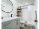 Bright bathroom featuring a modern vanity, round mirror and shower with decorative curtain at 3325 Horseshoe Dr, Longwood, FL 32779