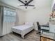 Cozy bedroom with natural light, ceiling fan, neutral color palette and wood-look flooring at 3325 Horseshoe Dr, Longwood, FL 32779
