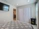 Bedroom view with marble floors, closet, television and connecting door to another room at 3325 Horseshoe Dr, Longwood, FL 32779