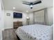 Bright bedroom with modern ceiling fan, TV, and stylish gray wood-look flooring at 3325 Horseshoe Dr, Longwood, FL 32779