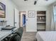 Bedroom featuring wood-look floors, a ceiling fan and closet space, with an open entry to another living area at 3325 Horseshoe Dr, Longwood, FL 32779