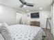 A bright bedroom with modern ceiling fan, TV, and wood look flooring at 3325 Horseshoe Dr, Longwood, FL 32779