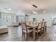 Bright dining area with modern light fixture and decor, with an open concept to the living room at 3325 Horseshoe Dr, Longwood, FL 32779