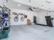 Open garage features ceiling fan, bike storage, work bench and space for a treadmill at 3325 Horseshoe Dr, Longwood, FL 32779