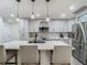 Modern kitchen featuring gray cabinetry, stainless steel appliances, pendant lighting, and island seating at 3325 Horseshoe Dr, Longwood, FL 32779