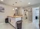 Bright kitchen with a butcher block island, white cabinets, and a view into the laundry room at 3325 Horseshoe Dr, Longwood, FL 32779