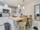 Eat-in kitchen featuring white cabinetry, stainless appliances, and a butcher block island with barstool seating at 3325 Horseshoe Dr, Longwood, FL 32779