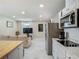 Open concept layout connecting the kitchen, dining area, and living room with marble floors at 3325 Horseshoe Dr, Longwood, FL 32779