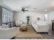 Bright living room featuring neutral furniture, a ceiling fan, and wood-look flooring at 3325 Horseshoe Dr, Longwood, FL 32779
