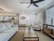 Open-concept living room showcasing stylish furnishings and seamless flow to the kitchen at 3325 Horseshoe Dr, Longwood, FL 32779