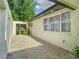 Side yard featuring gravel, stucco wall and tropical plants at 3325 Horseshoe Dr, Longwood, FL 32779