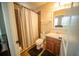 Functional bathroom with a vanity, toilet, and shower with a neutral-toned curtain, providing a clean and practical space at 338 Roberts Family Ln, Winter Springs, FL 32708