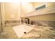 Close-up of a bathroom vanity with granite countertop and decorative fixtures at 338 Roberts Family Ln, Winter Springs, FL 32708