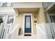Close-up of the home's entrance, showcasing a decorative glass door, white railings, and a welcoming aesthetic at 338 Roberts Family Ln, Winter Springs, FL 32708
